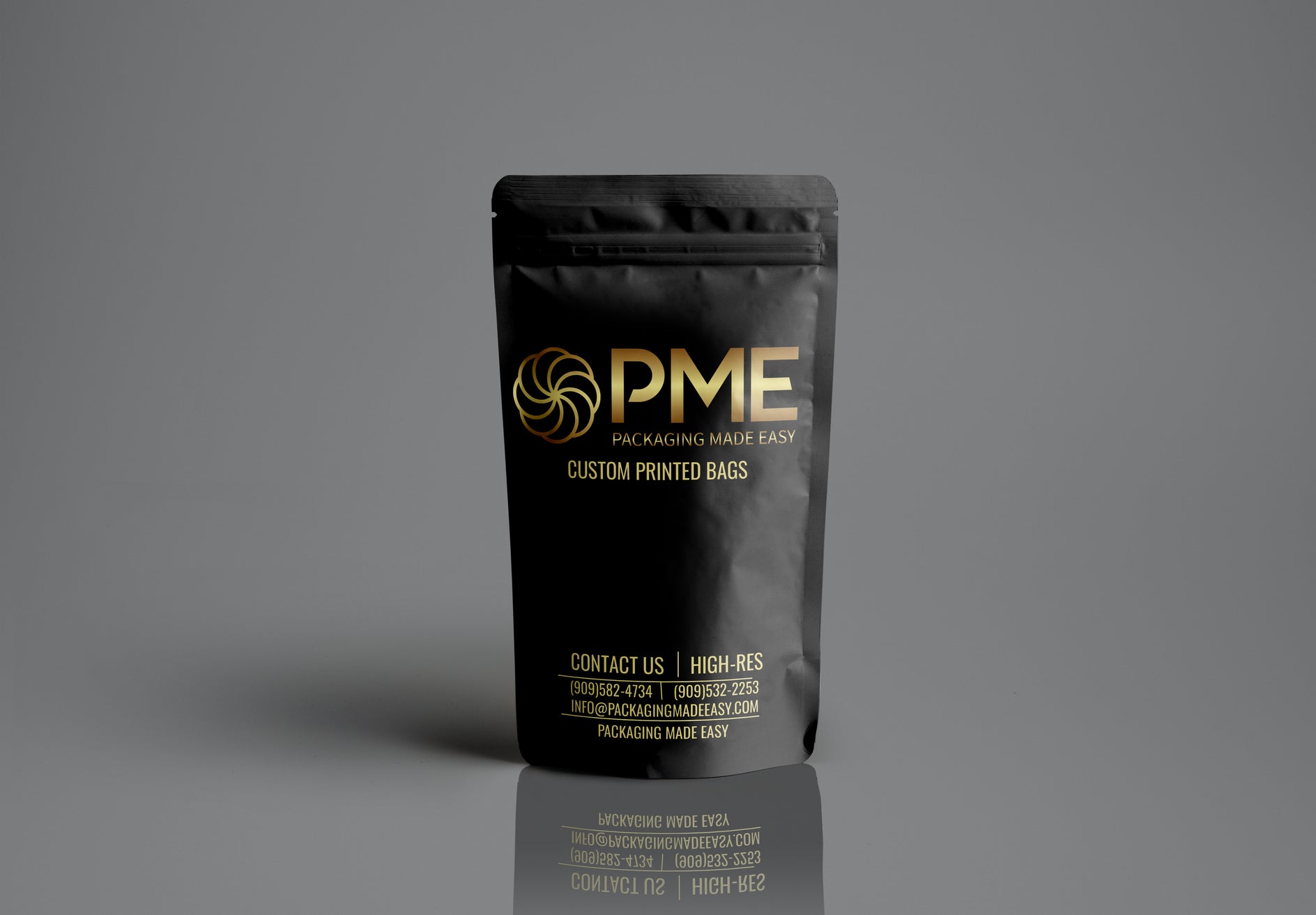 Black packaging bag with gold text on a gray background